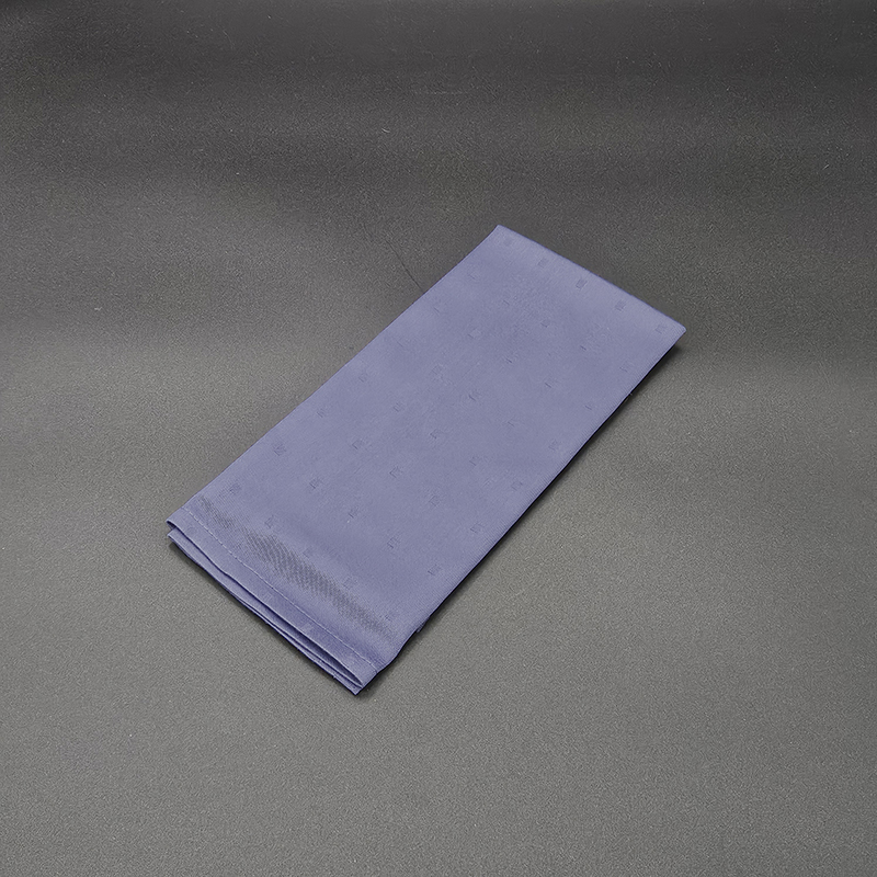 Eight shirts arranged on table in black, olive, grey, blue, white, red, mustard, and green.