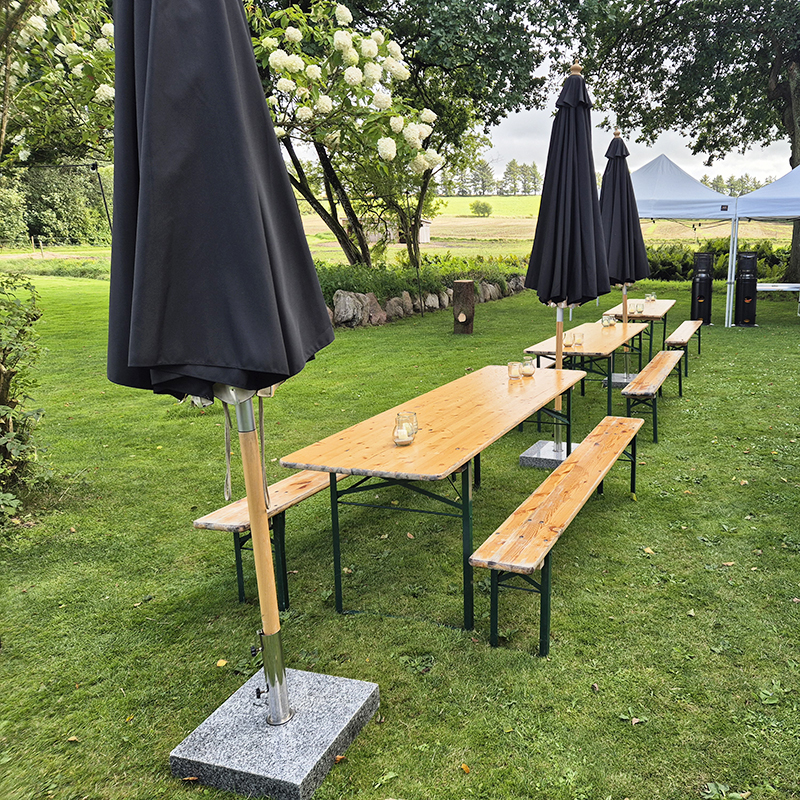 Eight shirts arranged on table in black, olive, grey, blue, white, red, mustard, and green.